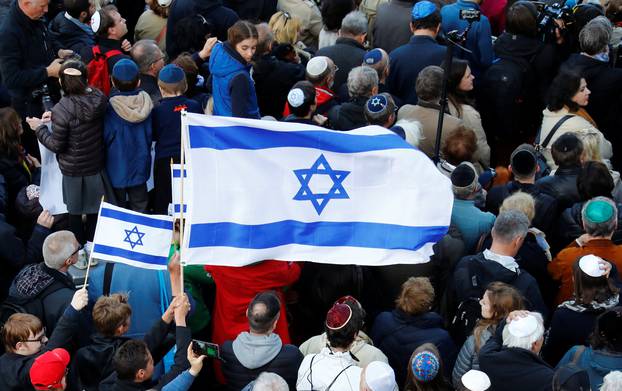 An Israeli flag is held during a demonstration in front of a Jewish synagogue in Berlin