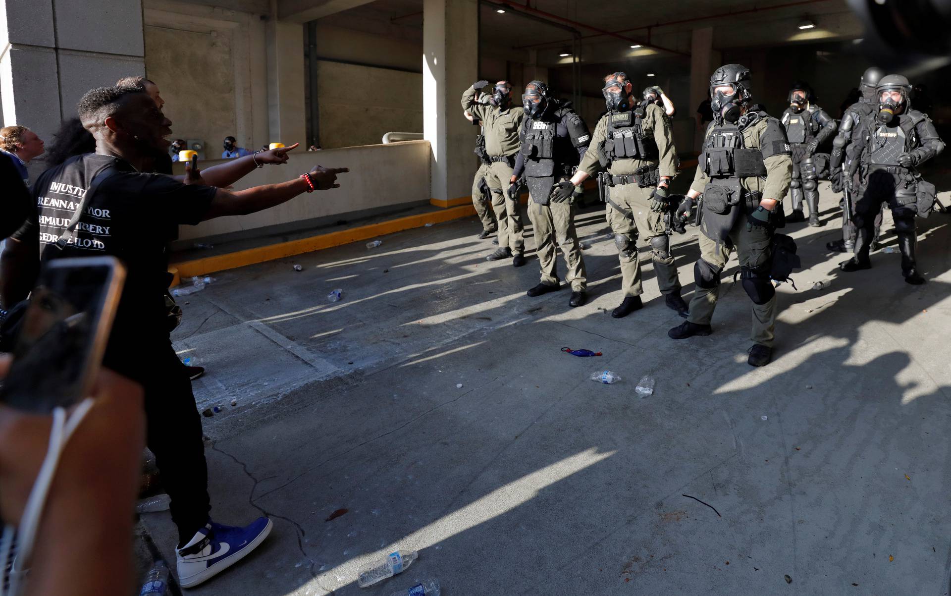 Protesters confront police in riot gear during nationwide unrest following the death in Minneapolis police custody of George Floyd, in Raleigh