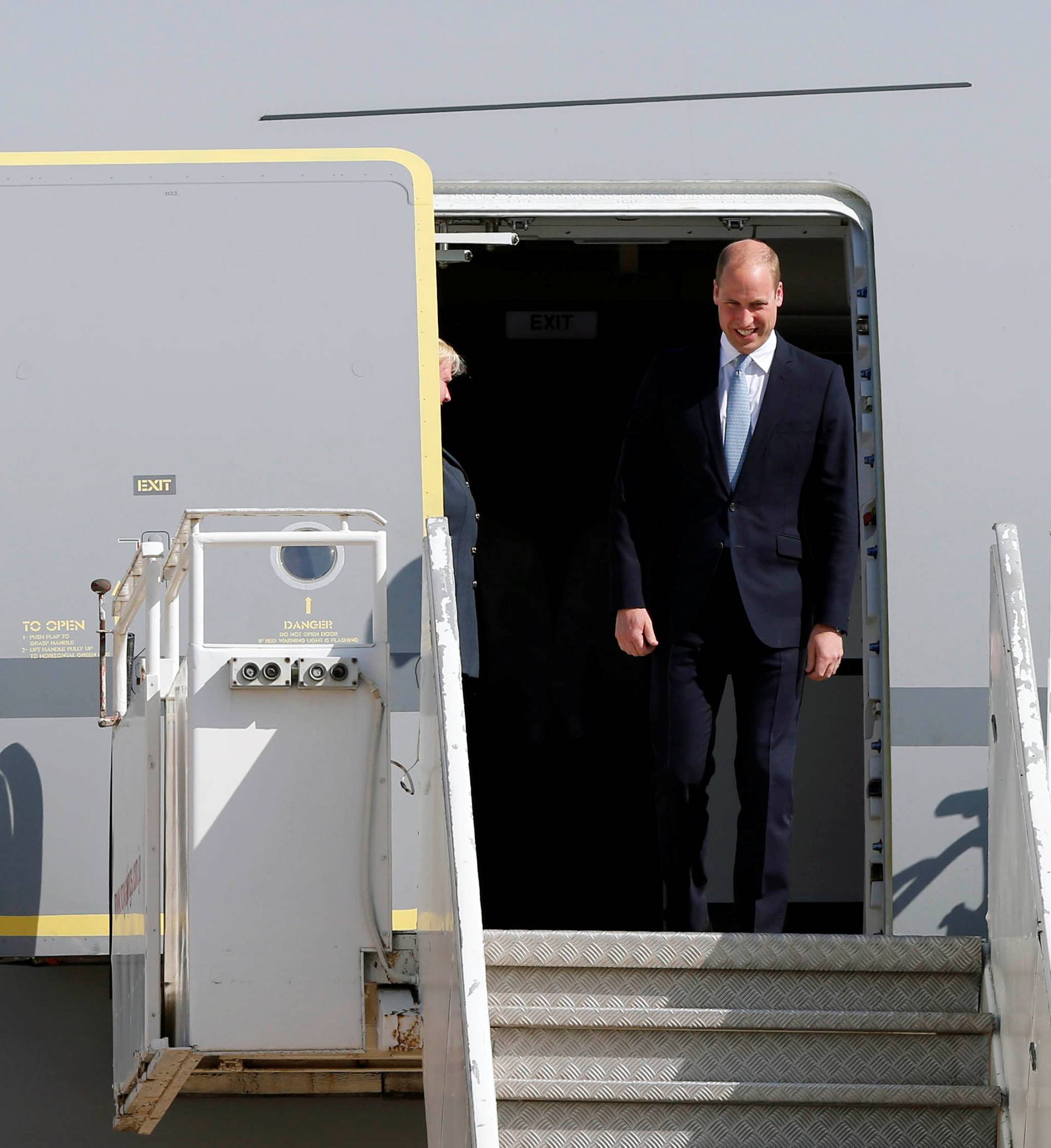 Britain's Prince William leaves the plane as he arrives in Amman
