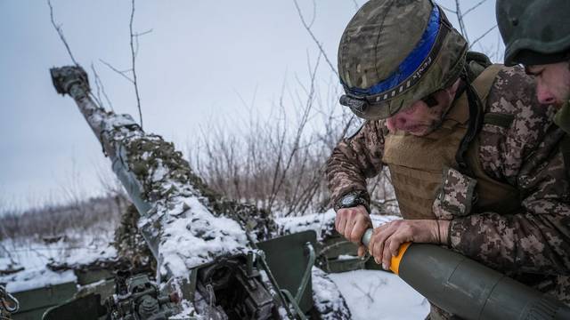 Ukrainian servicemen prepare fire a 120-mm towed artillery pieces-mortar towards Russian troops at a position near Bakhmut