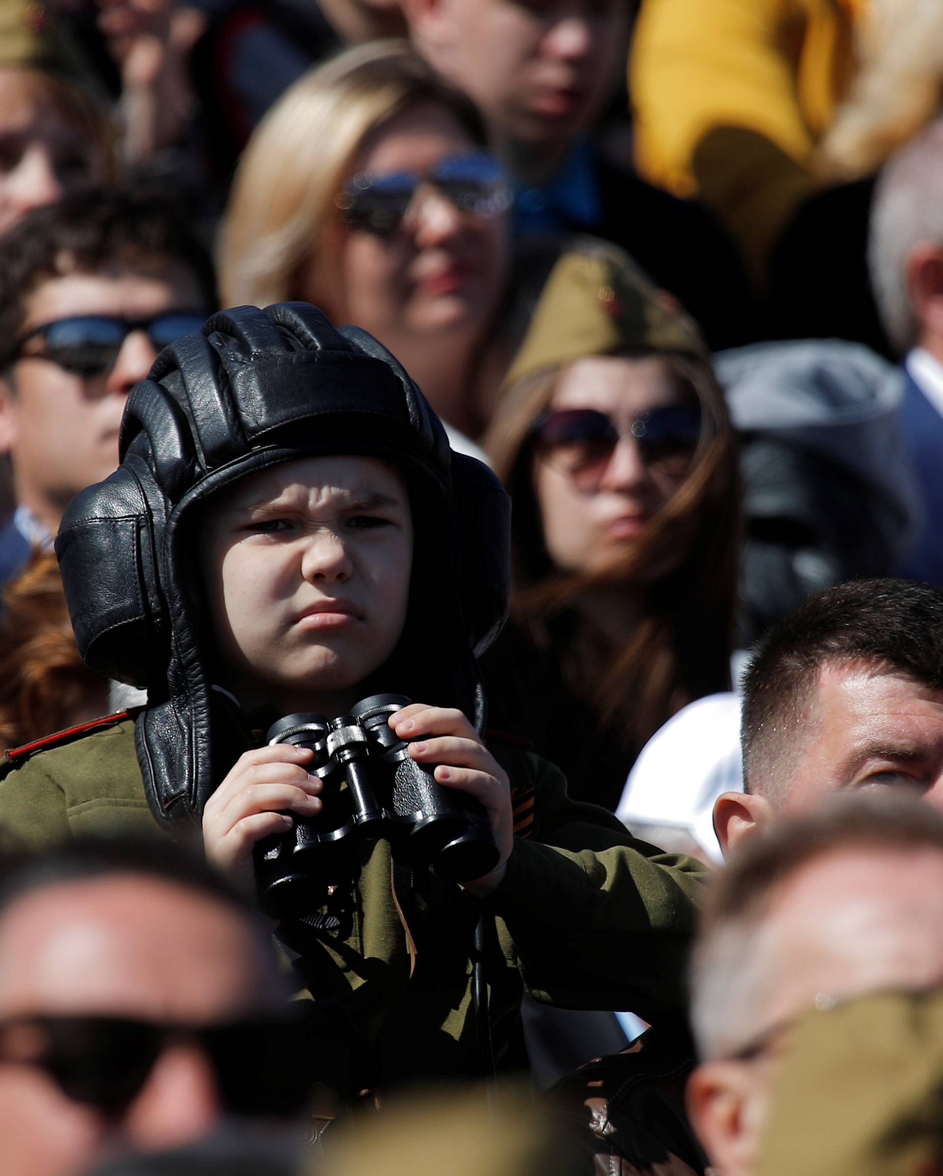 Specators watch the Victory Day parade at Red Square in Moscow