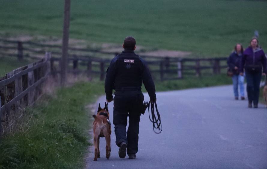 A police dog handler near the Borussia Dortmund team hotel after an explosion before the game