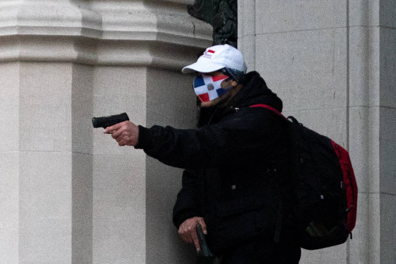 A man wearing a protective mask points his guns outside the Cathedral Church of St. John the Divine in Manhattan