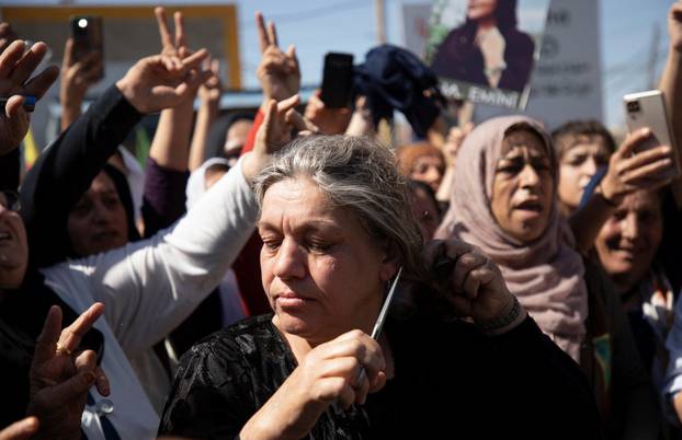 Women protest over the death of Mahsa Amini in Iran, in the Kurdish-controlled city of Qamishli