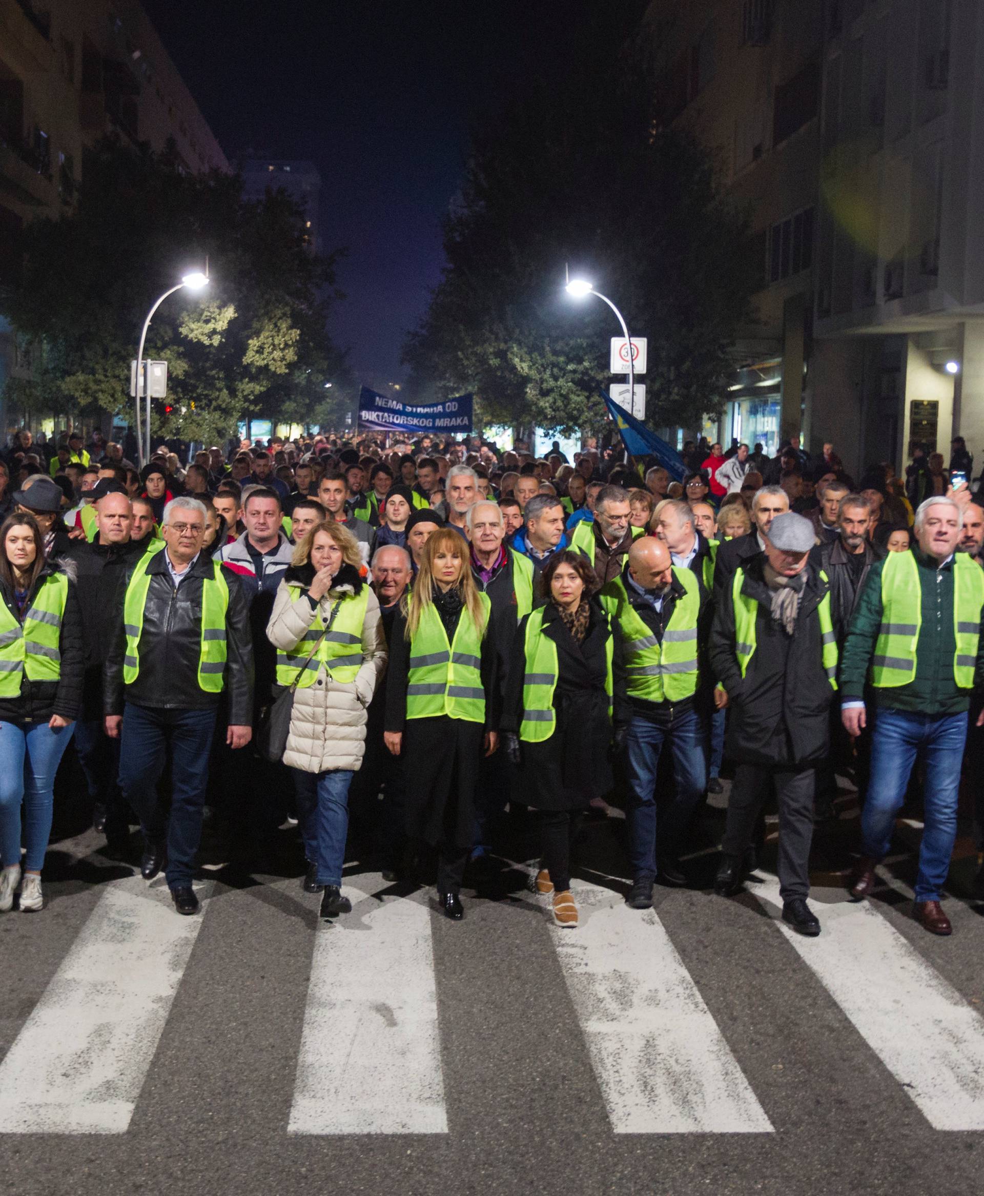 Protesters wearing yellow vests march against the arrest of Nebojsa Medojevic in Podgorica