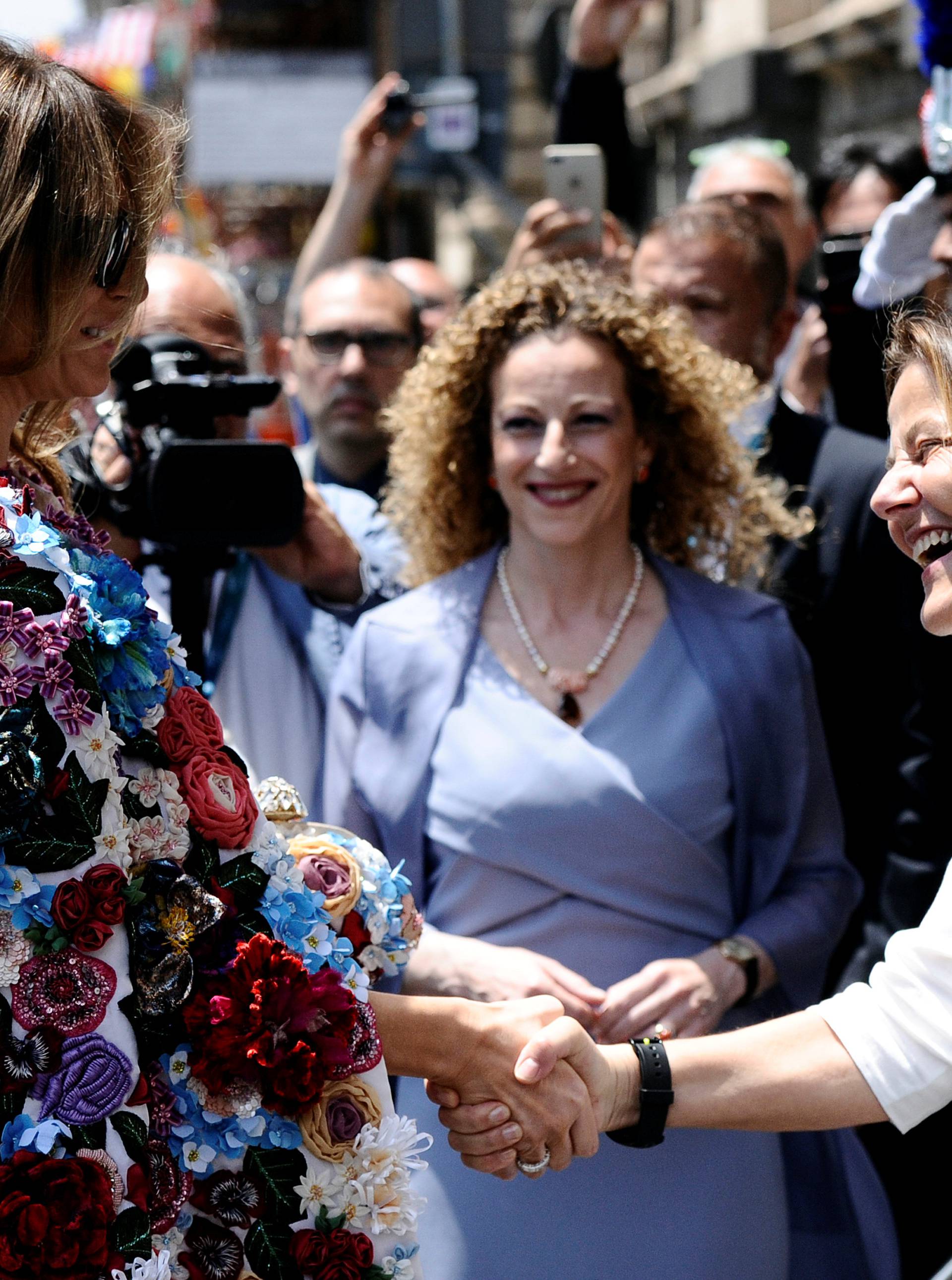 U.S. first lady Melania Trump shakes hands with Emanuela Mauro, wife of Italian PM Gentiloni, as she arrives at Duomo Square in the Sicilian town of Catania