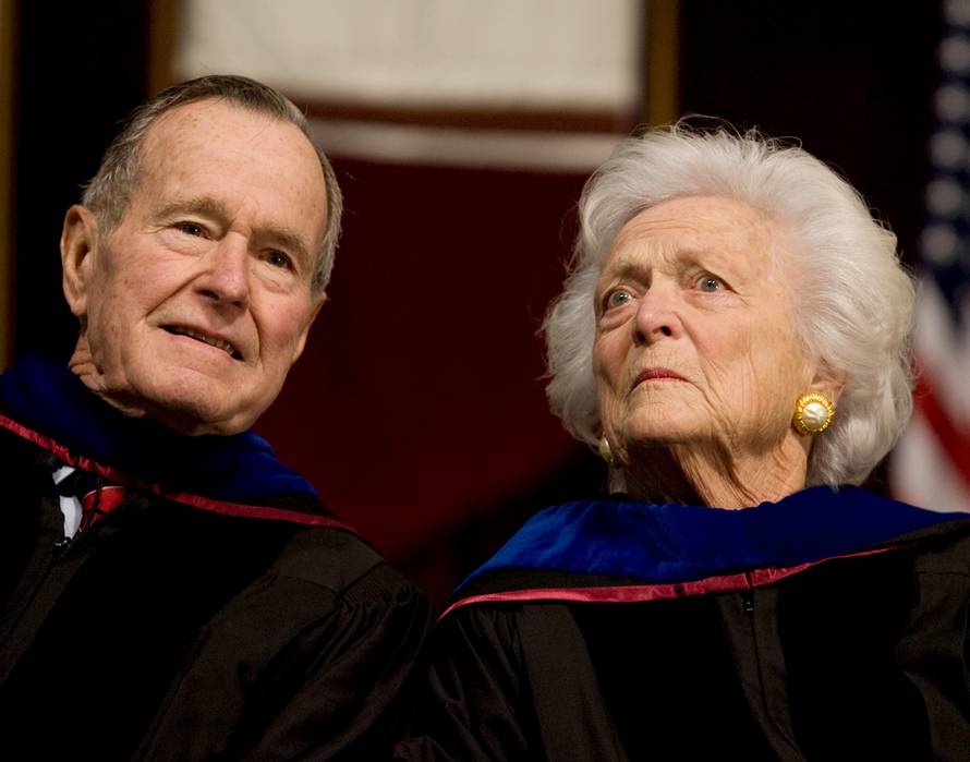 FILE PHOTO - Former President George H.W. Bush, and former first lady, Barbara Bush, attend the Texas A&M University commencement ceremony in College Station