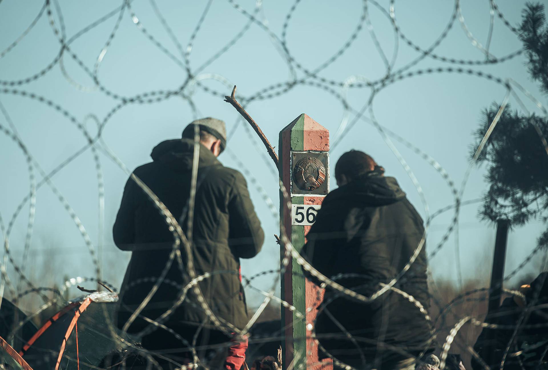 Migrants are seen on the Belarus side of the border with Poland near Kuznica