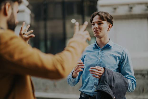 Two business people engaged in a conversation outdoors