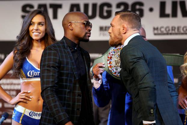Conor McGregor (R) of Ireland stares down Floyd Mayweather Jr. of the U.S. during a news conference in Las Vegas