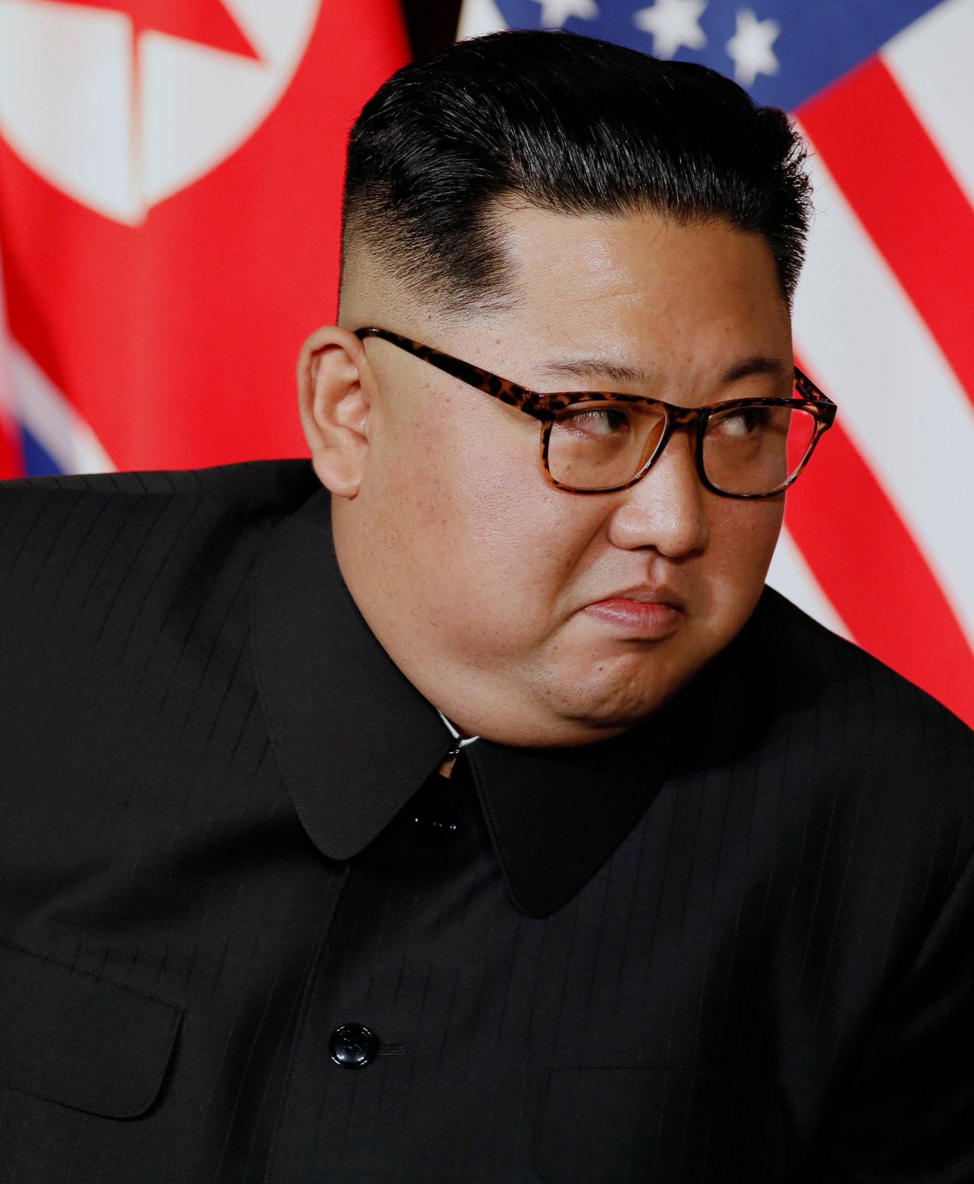 North Korea's leader Kim Jong Un looks at U.S. President Donald Trump before their meeting in Singapore