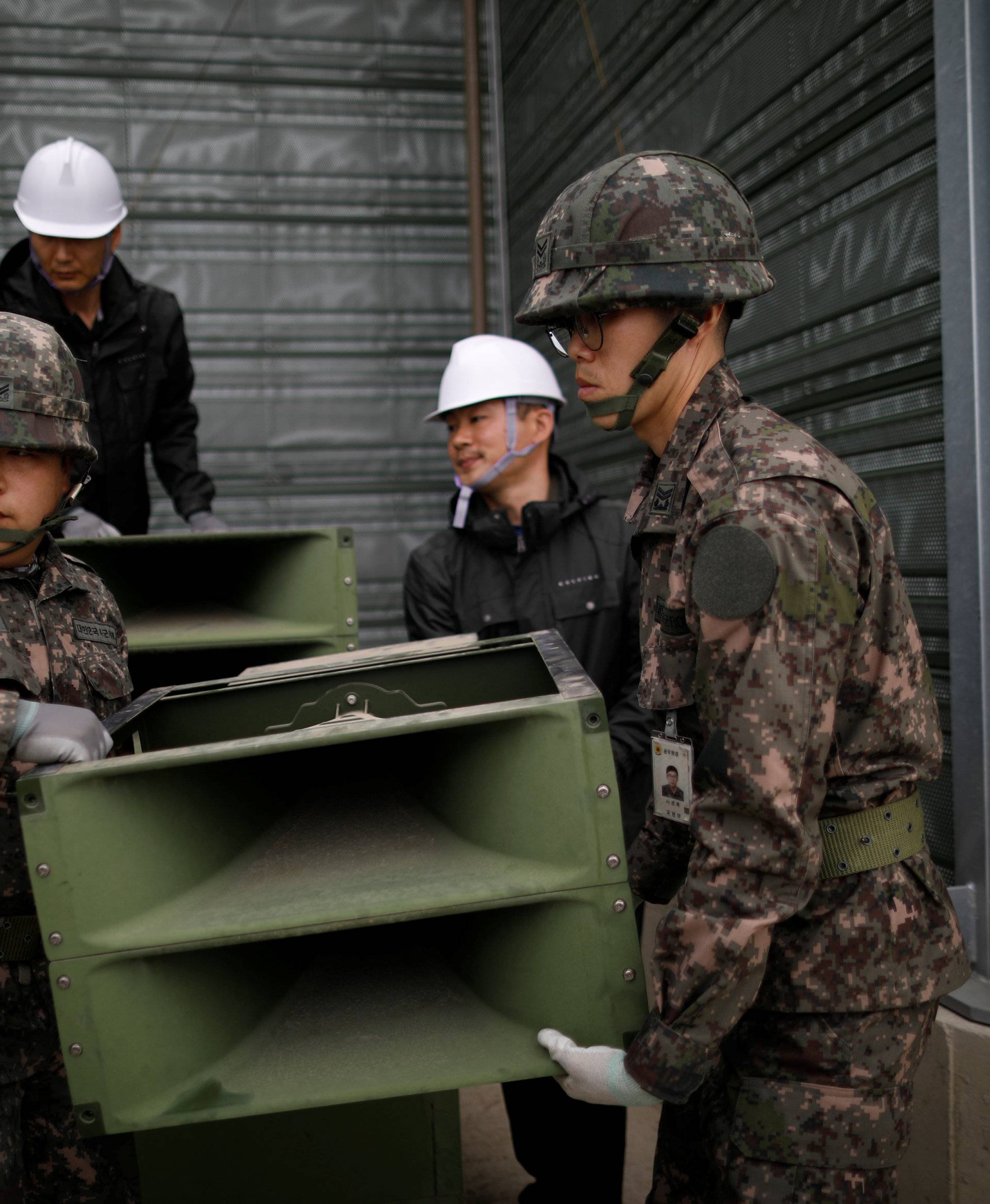 South Korean soldiers dismantle loudspeakers that were set up for propaganda broadcasts near the demilitarized zone separating the two Koreas in Paju