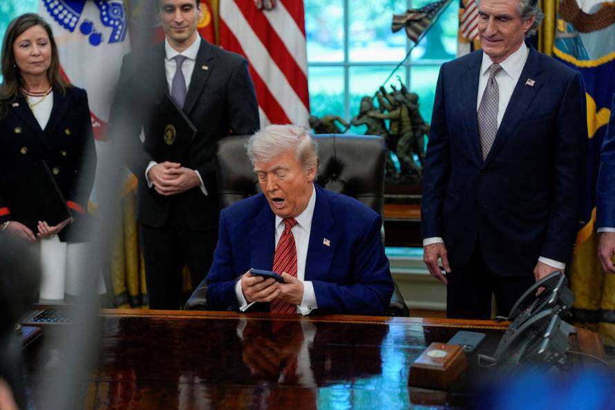 U.S. President Donald Trump signs executive orders at the White House in Washington