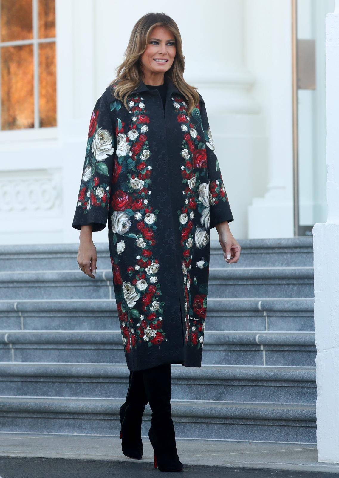 U.S. first lady Melania Trump walks out to receive the White House Christmas tree at the White House in Washington