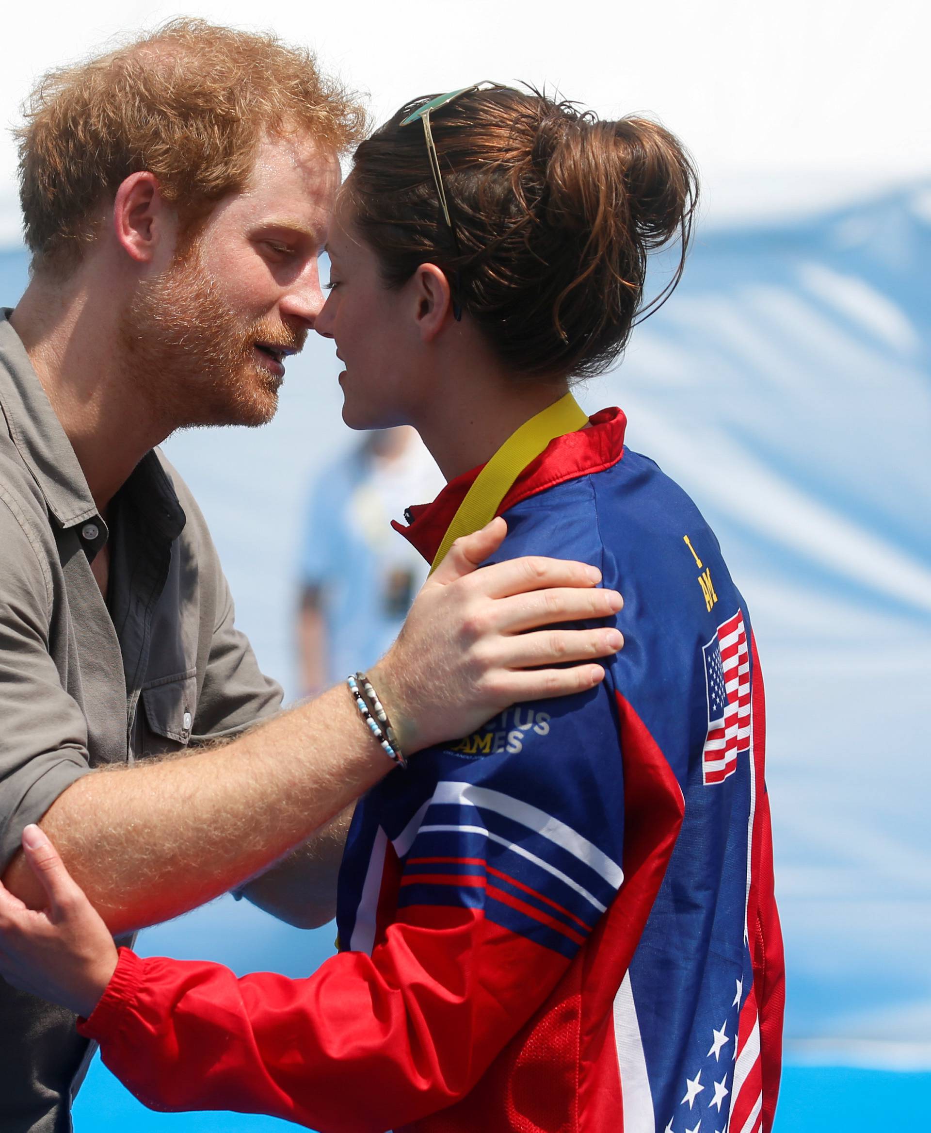 Britain's Prince Harry greets Elizabeth Marks of the U.S. after presenting her with a gold medal during a medal ceremony at the Invictus Games in Orlando
