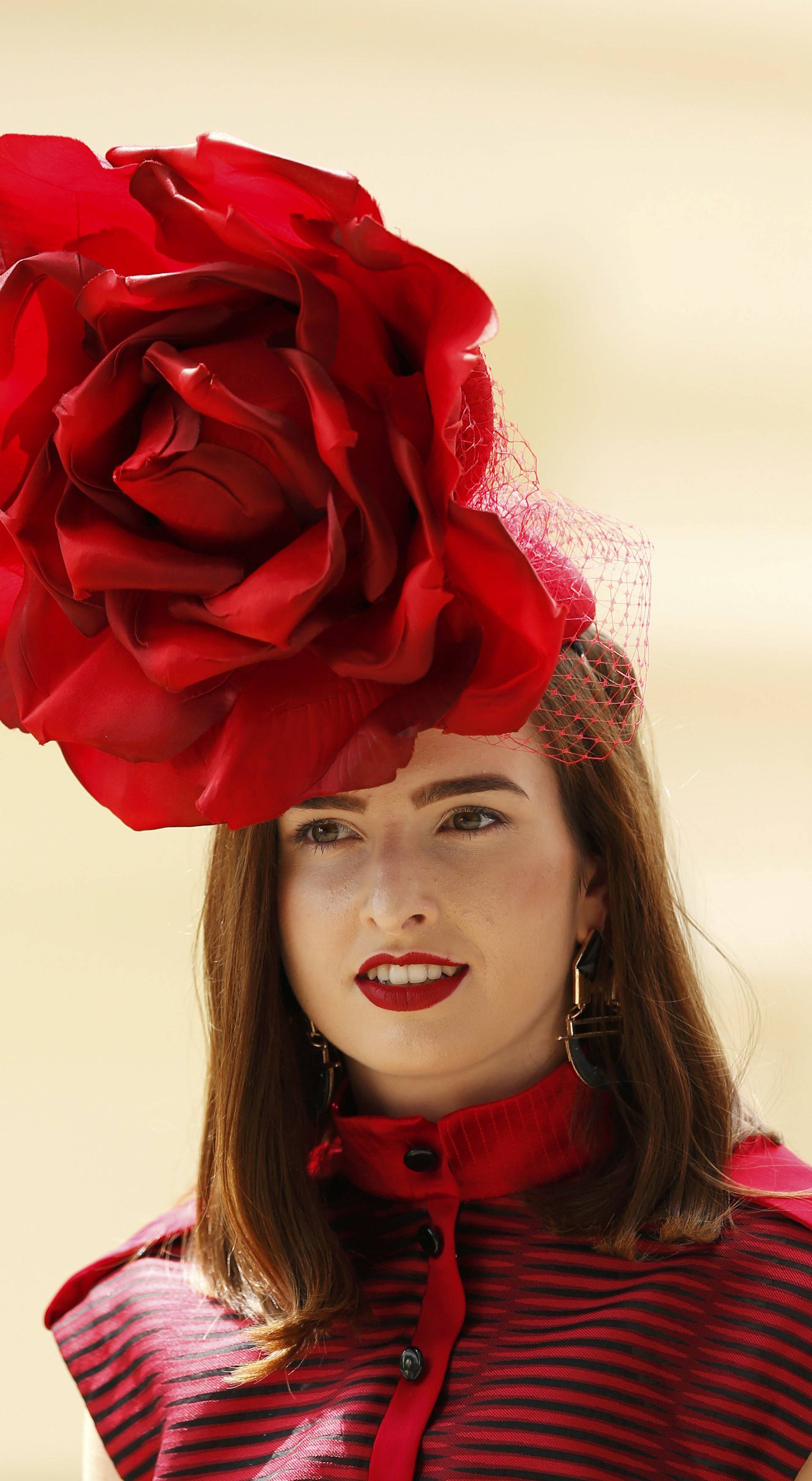 Britain Horse Racing Ladies Day Racegoer wears hat