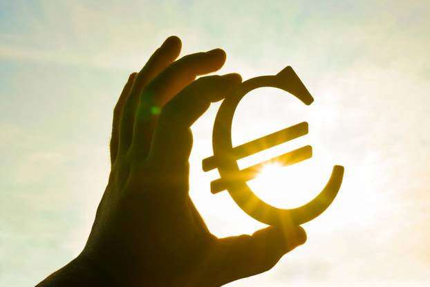 Man's,Hand,Hold,The,Euro,Icon,Silhouette,Against,Sunny,Blue,