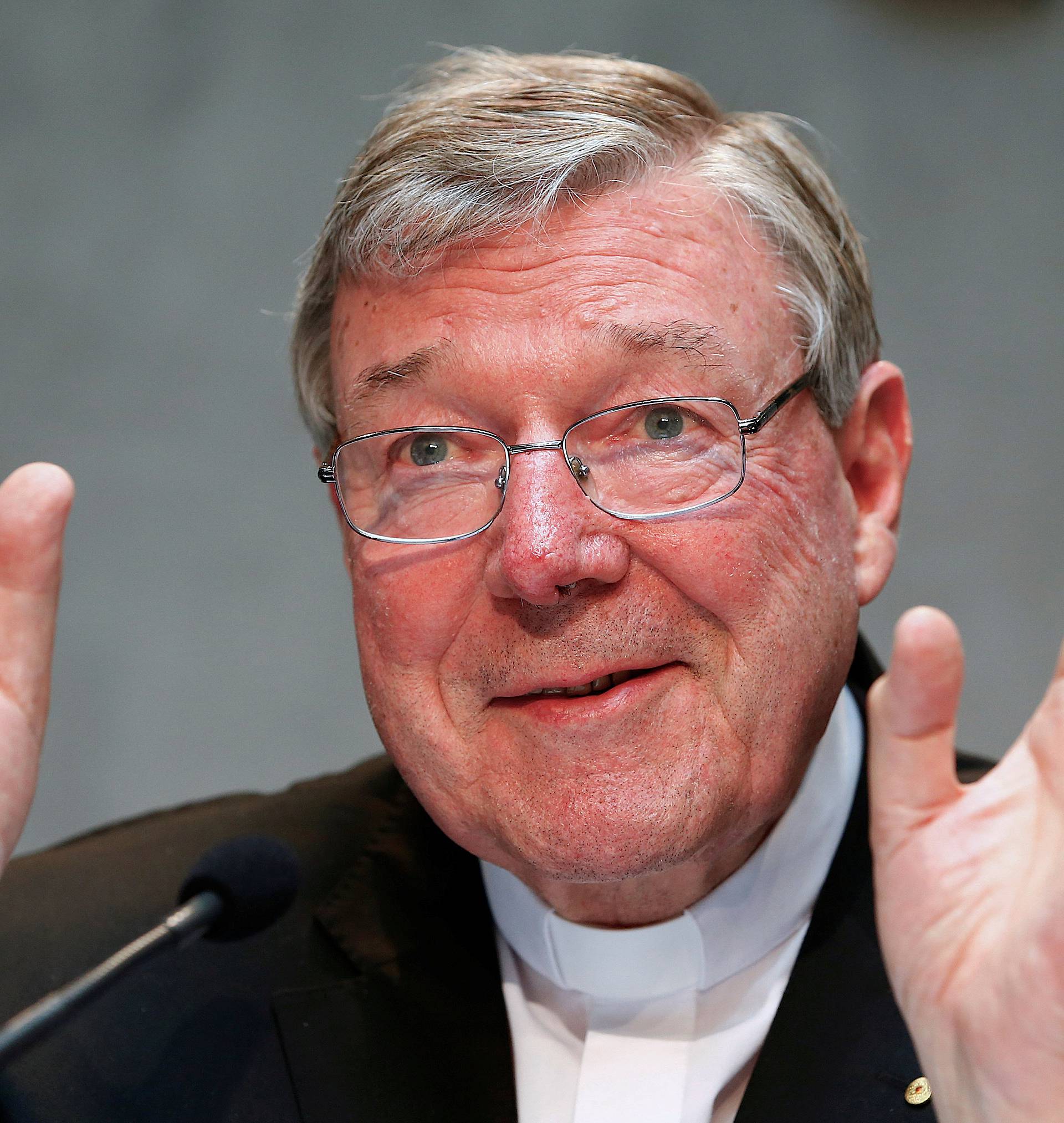 FILE PHOTO - Cardinal George Pell gestures as he talks during a news conference for the presentation of new president of Vatican Bank IOR at the Vatican