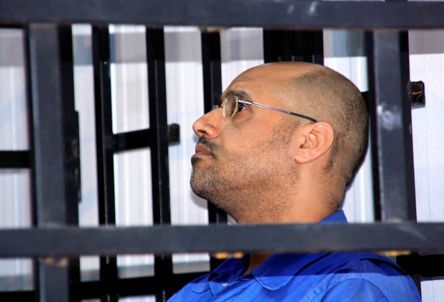 FILE PHOTO: Saif al-Islam Gaddafi, son of late Libyan leader Muammar Gaddafi, attends a hearing behind bars in a courtroom in Zintan