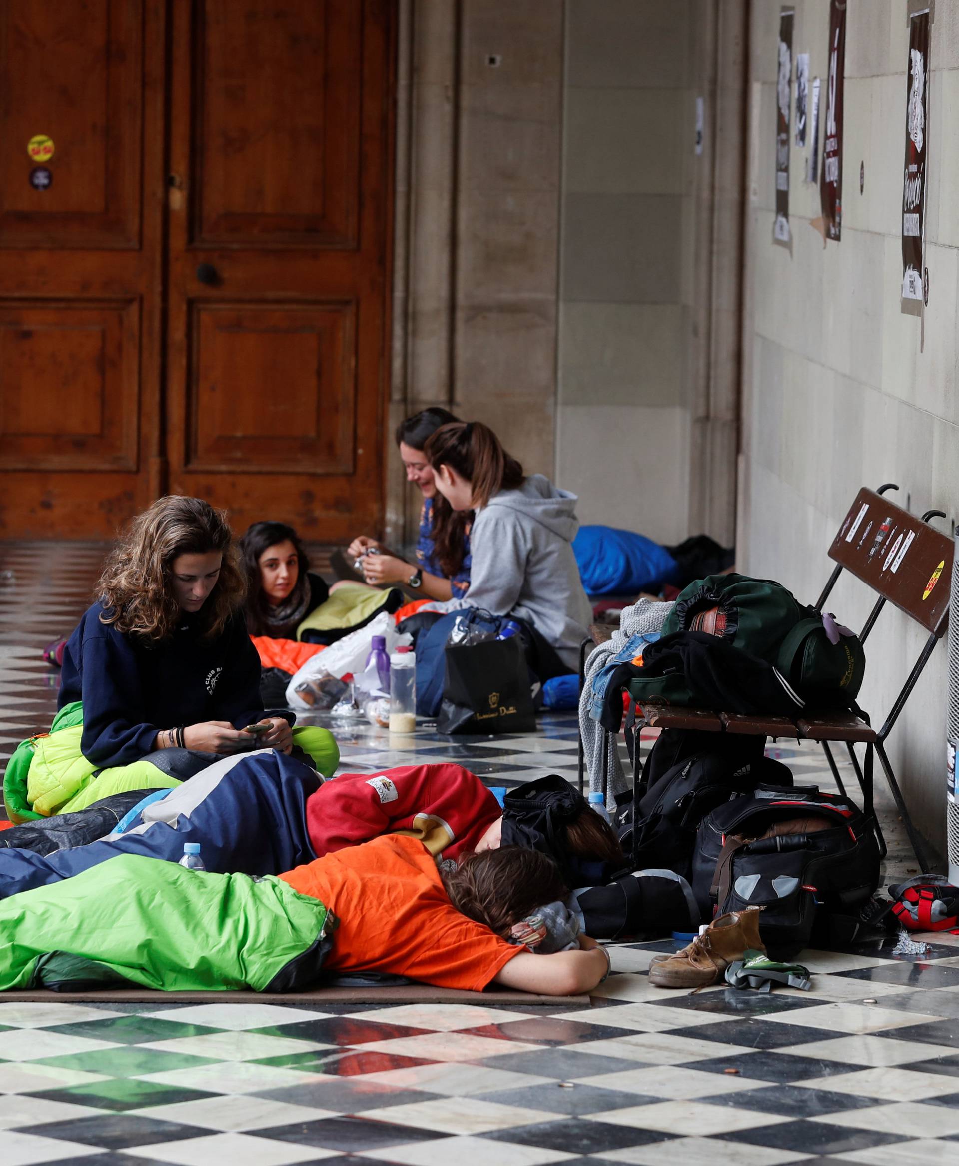 People wake up after speding the night inside the University of Barcelona's historic building during a protest in favour of the banned October 1 independence referendum, in Barcelona