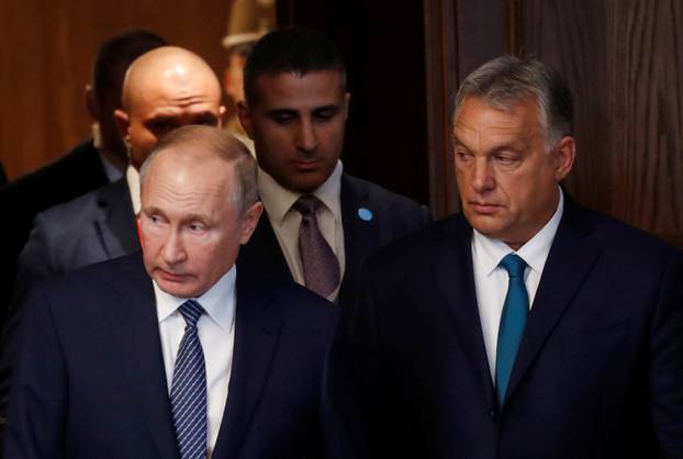 Hungarian Prime Minister Viktor Orban and Russian President Vladimir Putin arrive to attend a signing ceremony following their talks in Budapest
