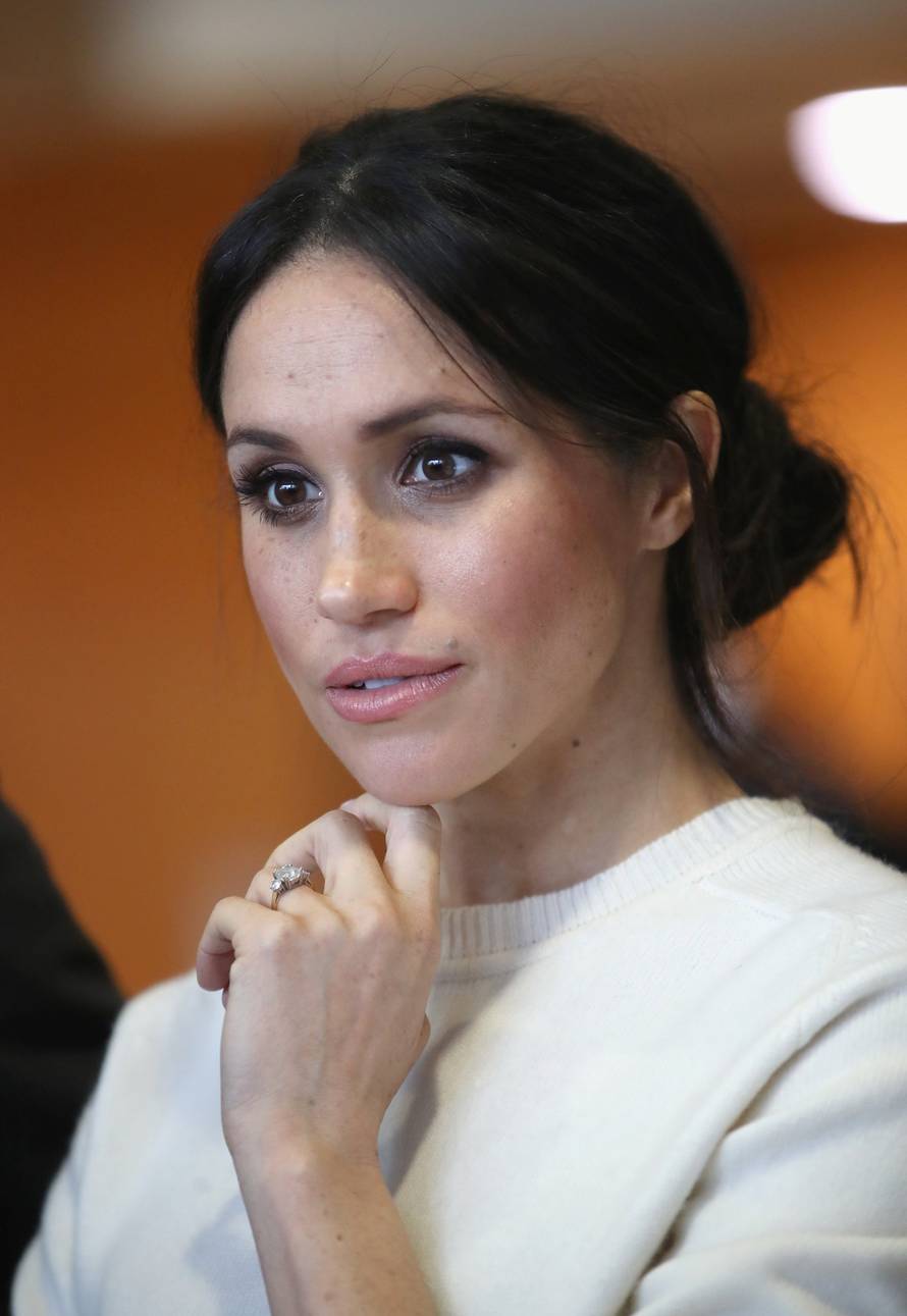 The fiancee of Britain's Prince Harry, Meghan Markle, reacts during a visit to a science park called Catalyst Inc., in Belfast
