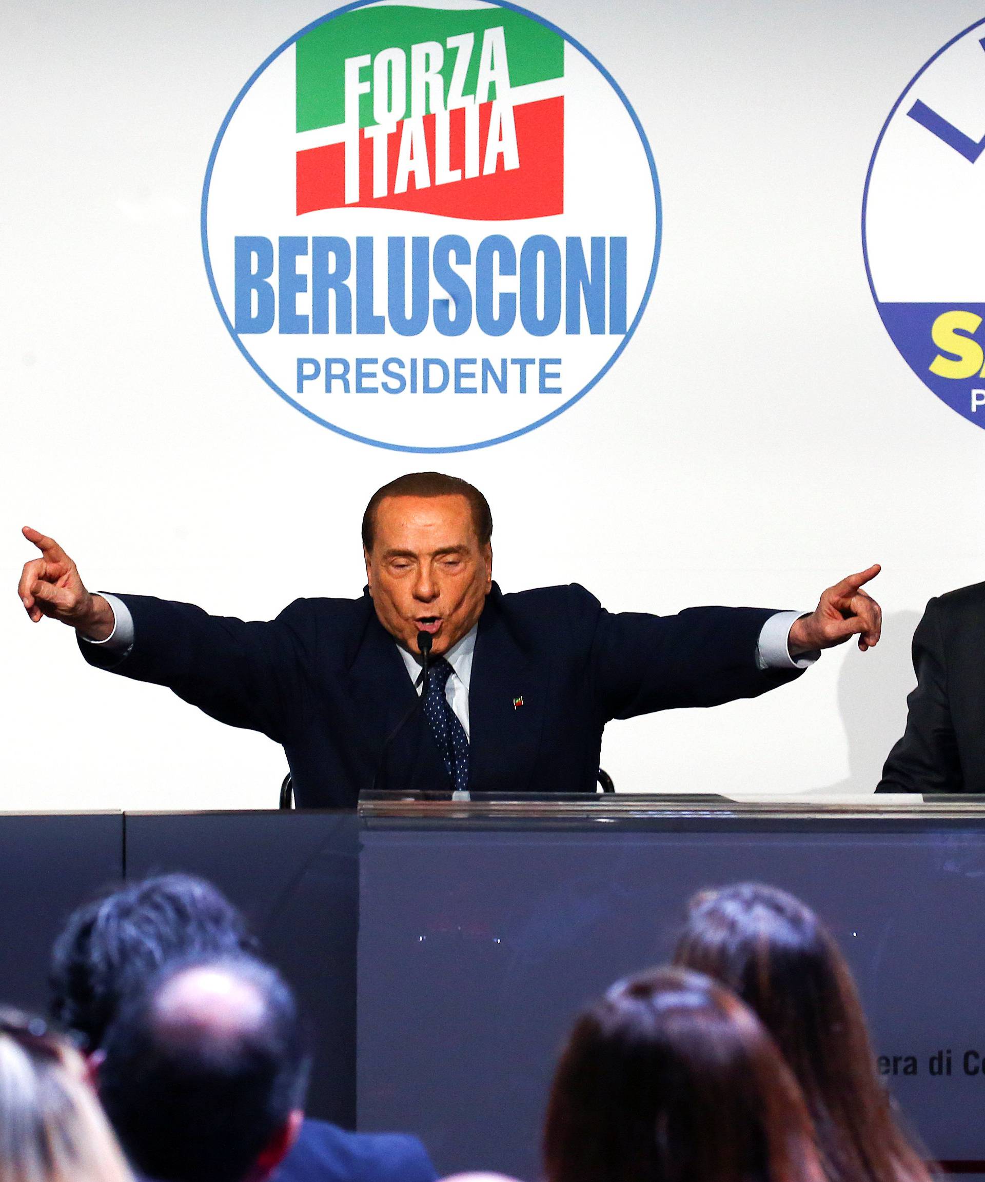 Forza Italia leader Silvio Berlusconi speaks flanked by Fratelli D'Italia party leader Giorgia Meloni and Northern League leader Matteo Salvini during a meeting in Rome