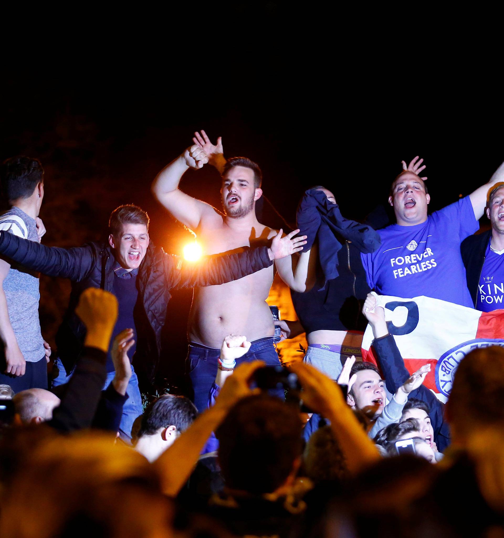 Leicester City fans celebrate their team winning the English Premier League outside the home of player Jamie Vardy in Melton Mowbray