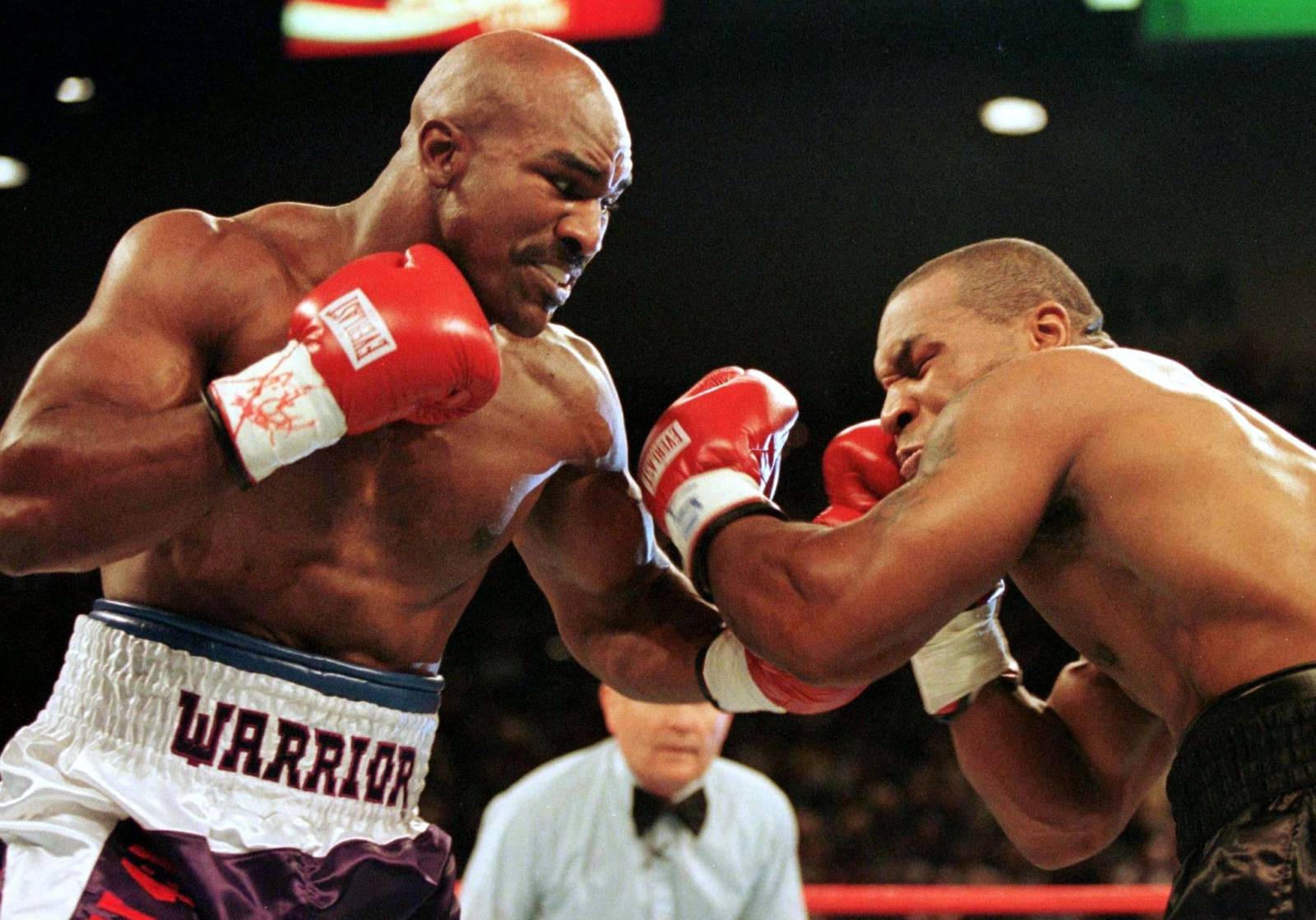 FILE PHOTO: WBA Heavyweight Champion Evander Holyfield (R) connects to the jaw of challenger Mike Tyson in the f..