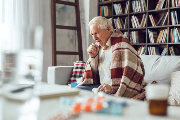 Senior,Man,Alone,Sitting,On,Sofa,At,Library,Covered,With