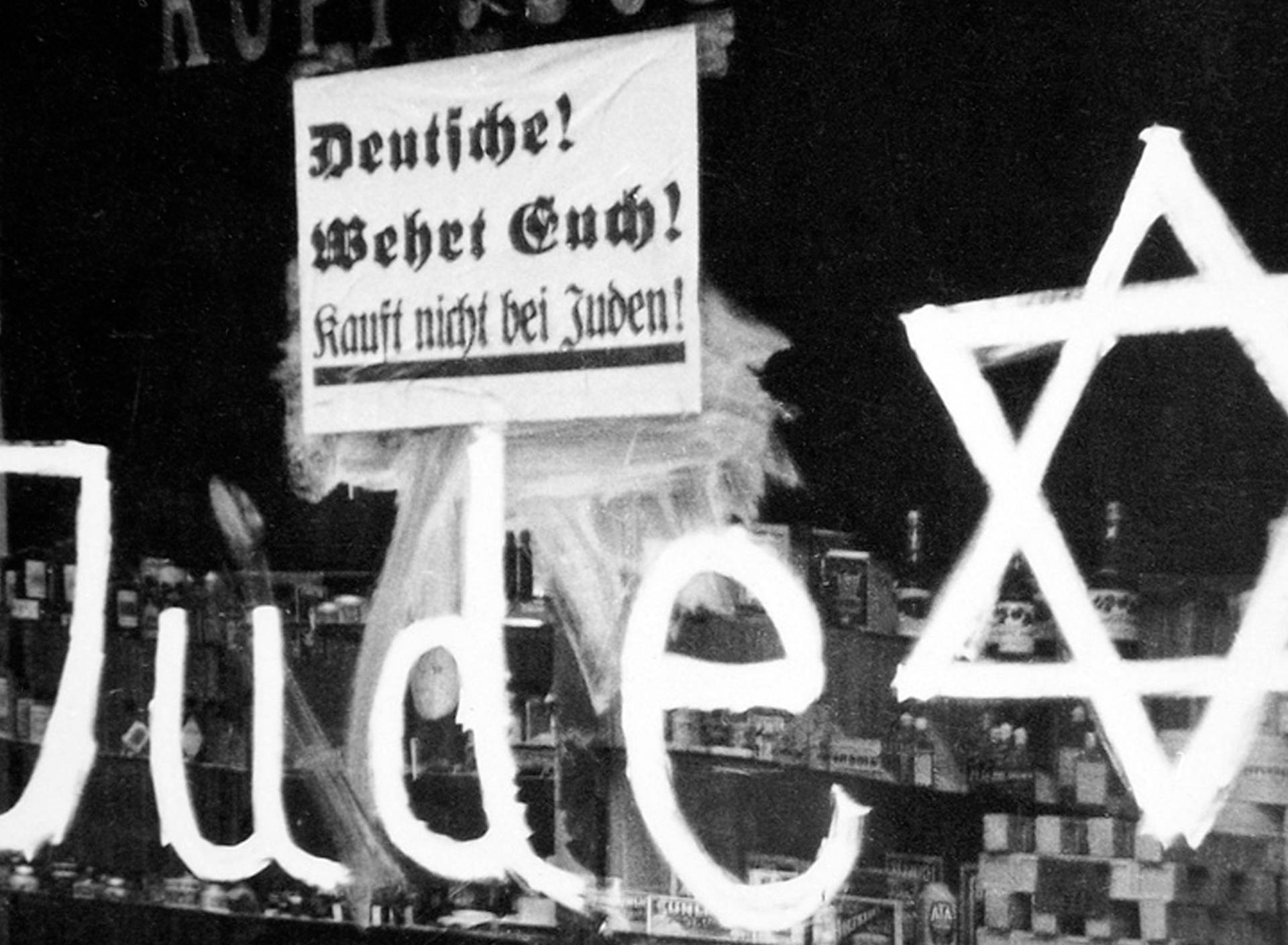Germany: A Jewish-owned shop vandalized by Nazis with poster reading 'Germans Defend Yourselves - Don't Buy from Jews', 1938