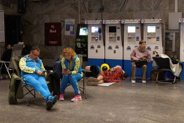 People shelter in a metro station during Russian missile and drone attacks in Kyiv
