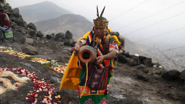 Peruvian's shamans give their predictions for 2022 during a traditional ritual prior to New Year's Eve at San Cristobal hill in Lima