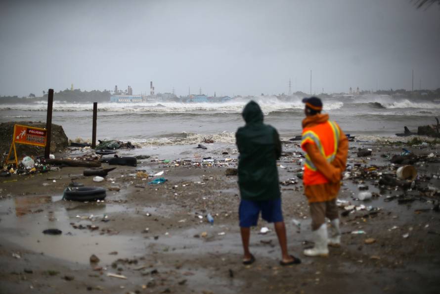 People look out to the sea as Hurricane Irma moves off the northern coast of the Dominican Republic