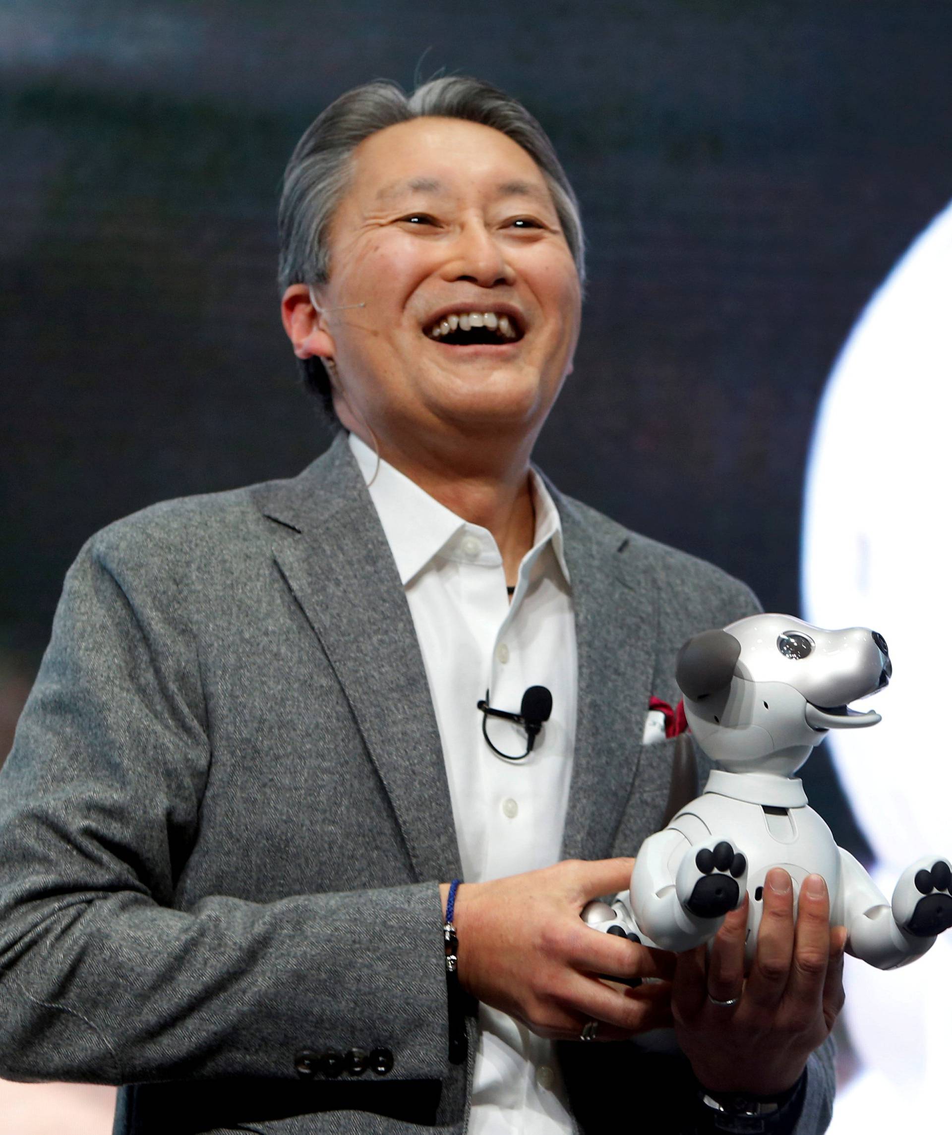 Kazuo Hirai, president and CEO of Sony Corporation, holds an Aibo robotic dog during a news conference at the 2018 CES in Las Vegas