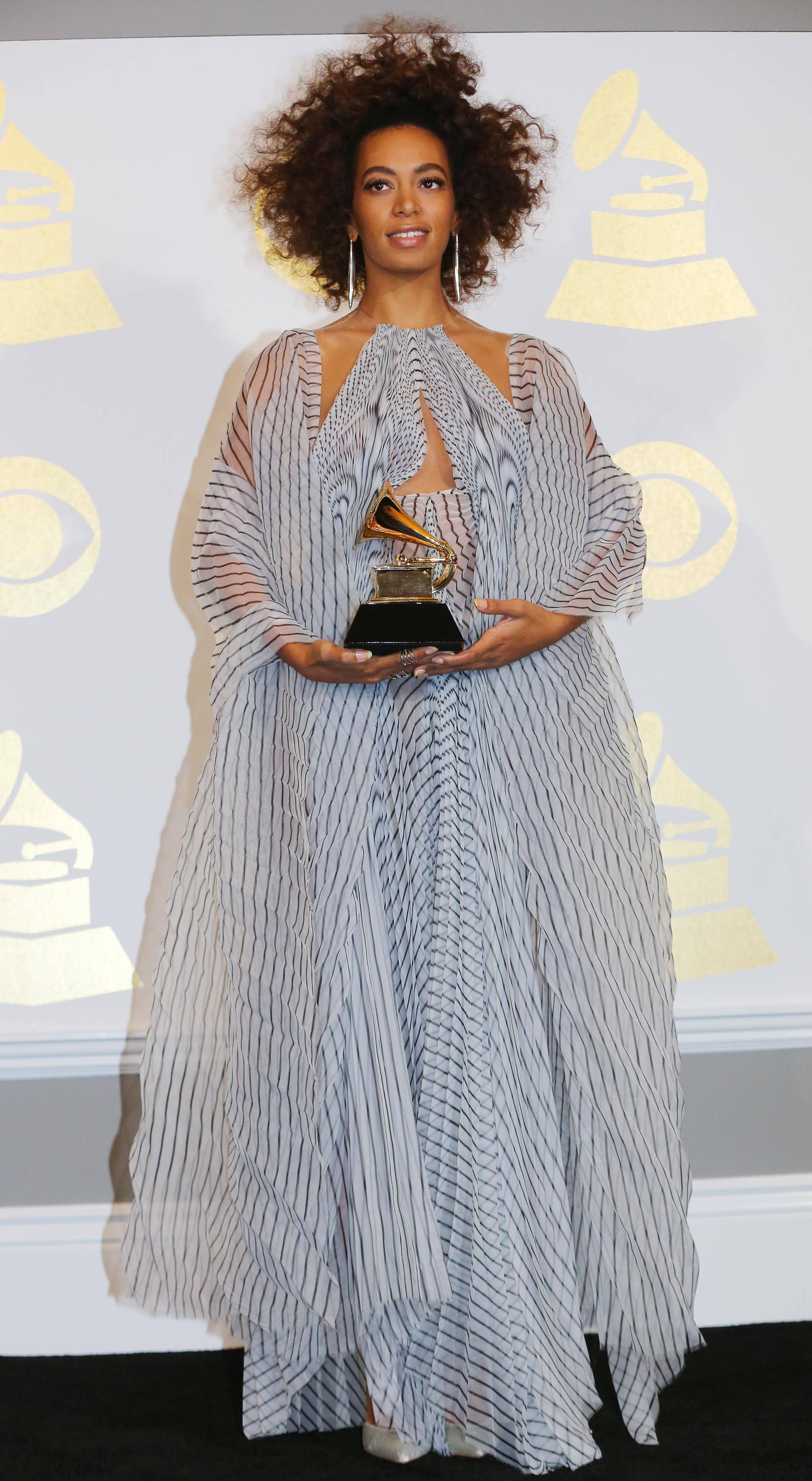 Solange poses with the award she won for Best R&B Performance for "Cranes in the Sky" at the 59th Annual Grammy Awards in Los Angeles
