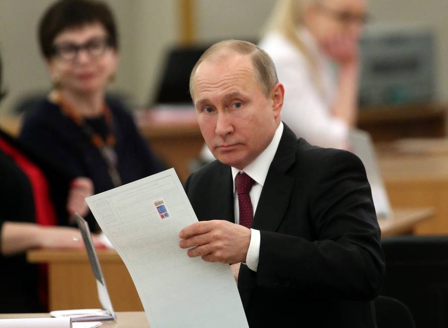 Russian President and Presidential candidate Vladimir Putin at a polling station during the presidential election in Moscow