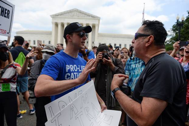 Abortion rights supporters and anti-abortion demonstrators face off outside the United States Supreme Court, in Washington