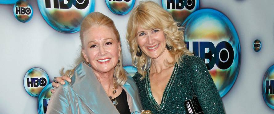 FILE PHOTO: Actress Laura Dern holds her award as she poses with her mother Diane Ladd at the 69th annual Golden Globe Awards in Beverly Hills