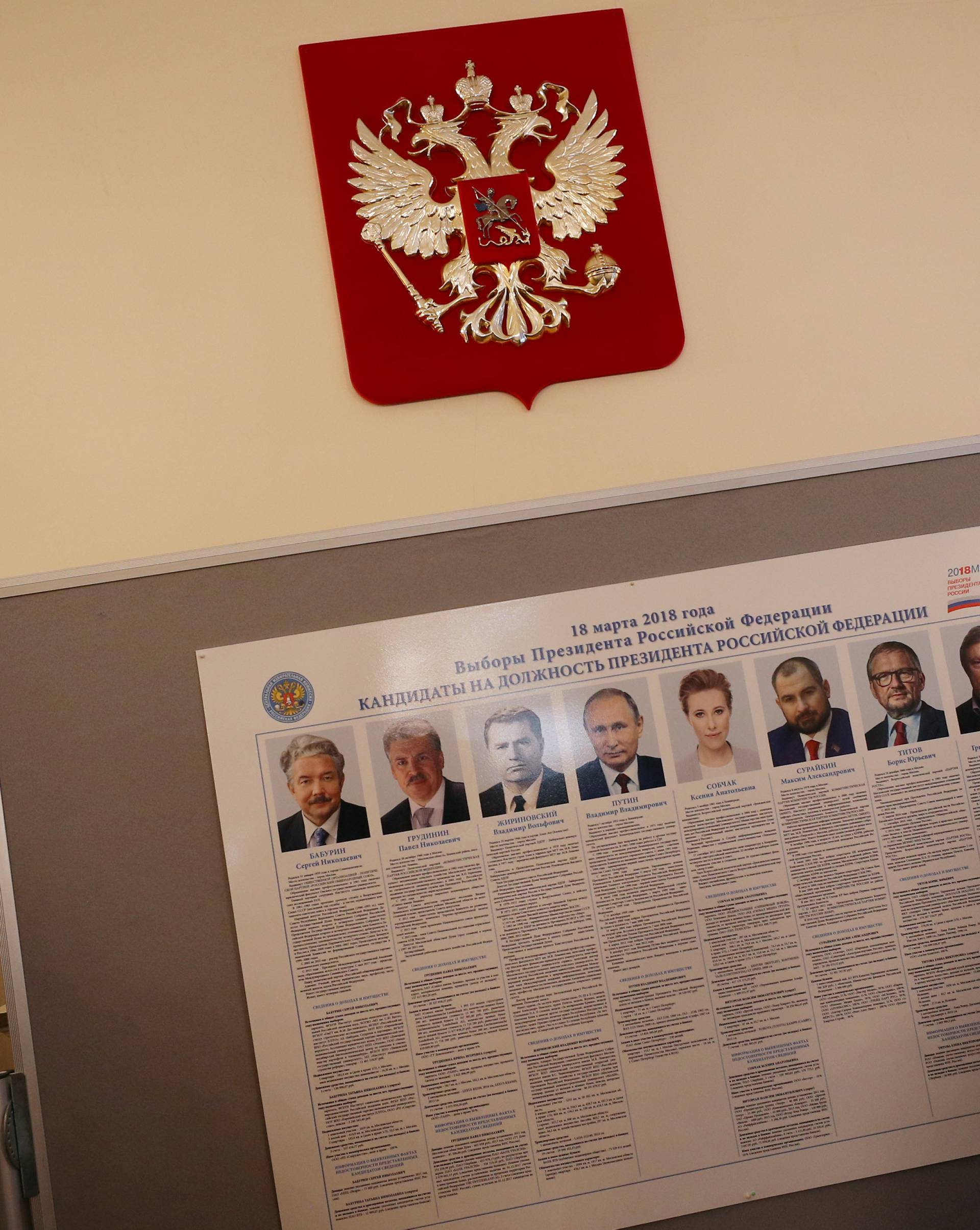 A woman looks at a list of candidates in the presidential election, inside the Russian Embassy in London