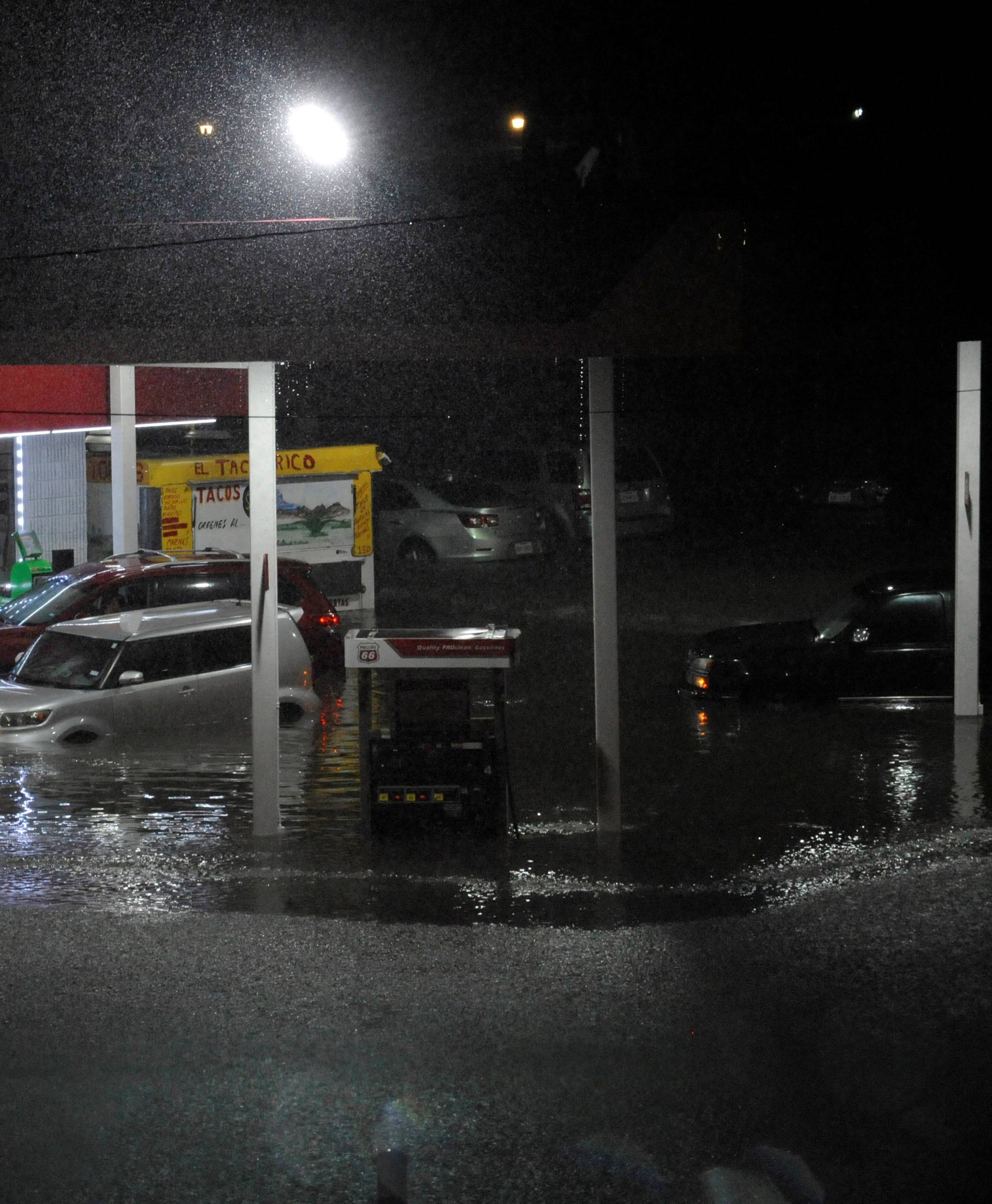 Cars sit abandoned at a flooded gas station after Hurricane Harvey made landfall on the Texas Gulf coast and brought heavy rain to the region
