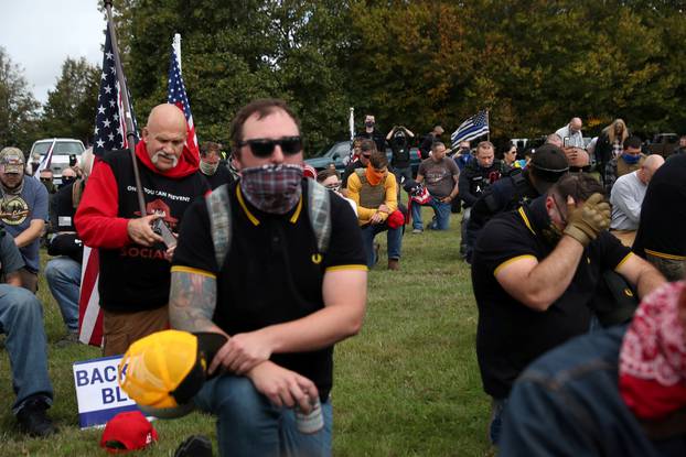 FILE PHOTO: Supporters of the far right group Proud Boys pray as they attend a rally in Portland