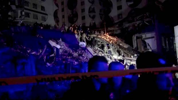 Rescuers search through rubble following an earthquake in Diyarbakir