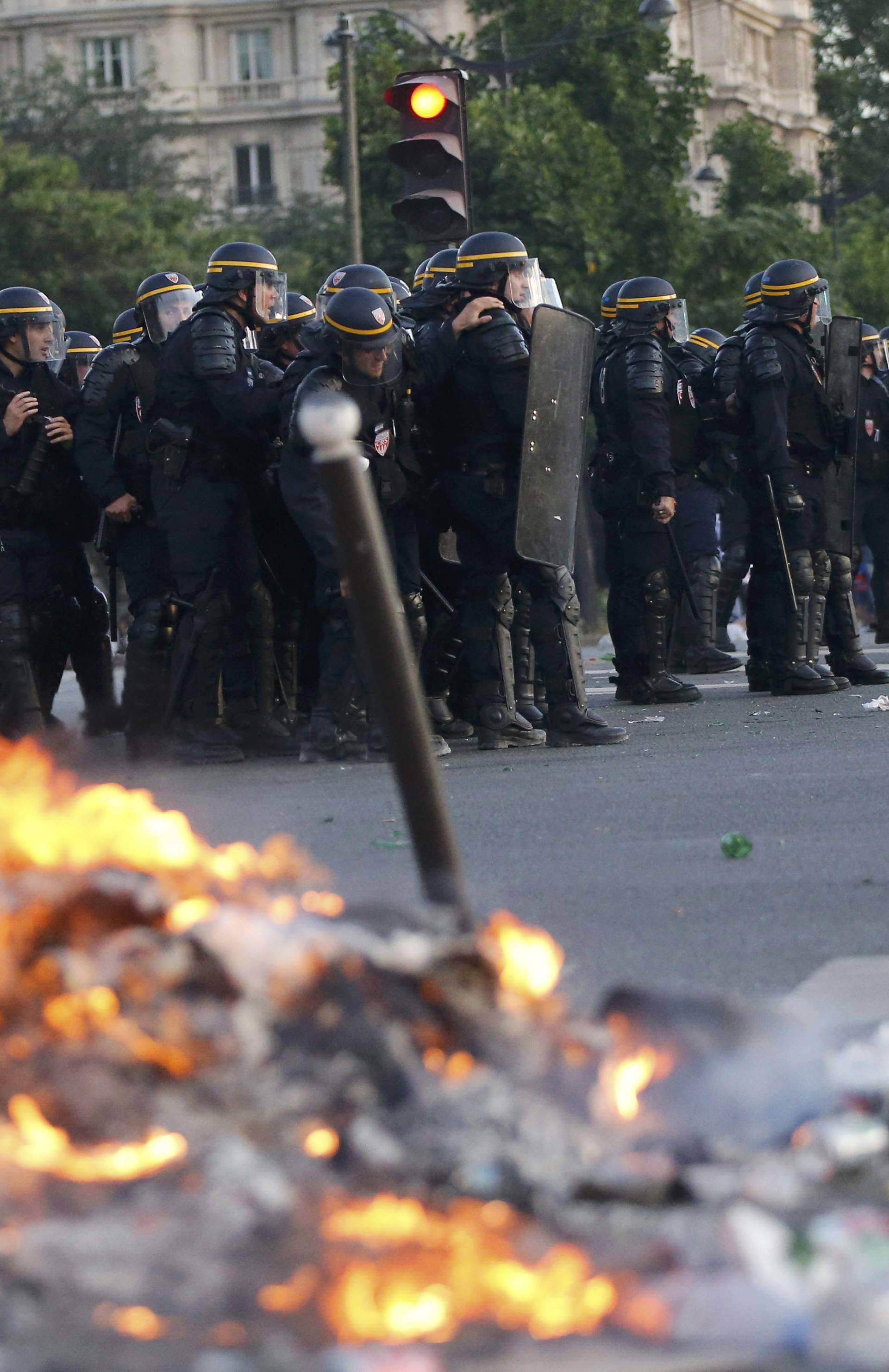 French CRS riot police secure the area during clashes outside the Paris fan zone during a EURO 2016 final soccer match       