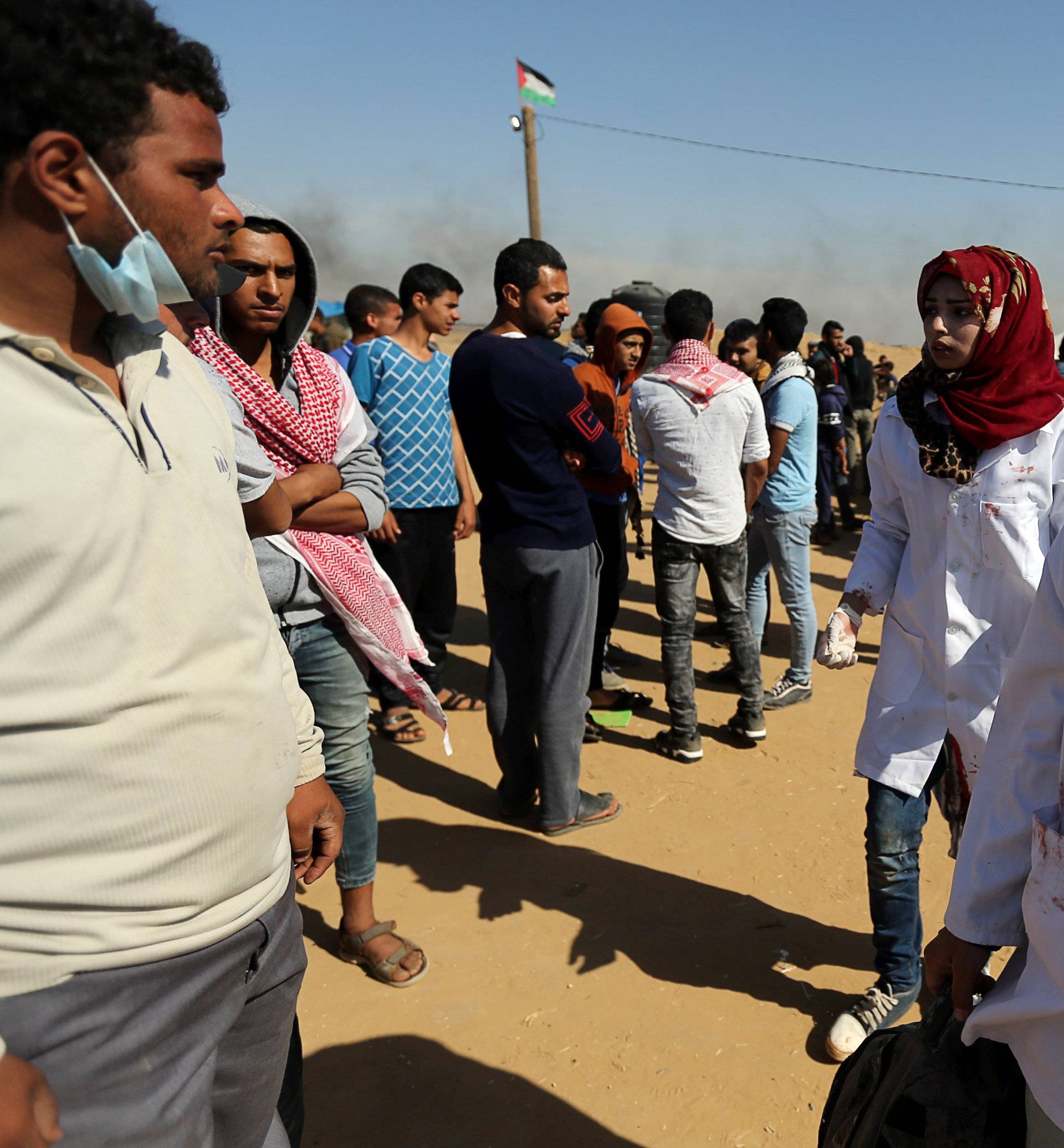 Female Palestinian medic Razan Al-Najar works at the scene of clashes at Israel-Gaza border, in the southern Gaza Strip