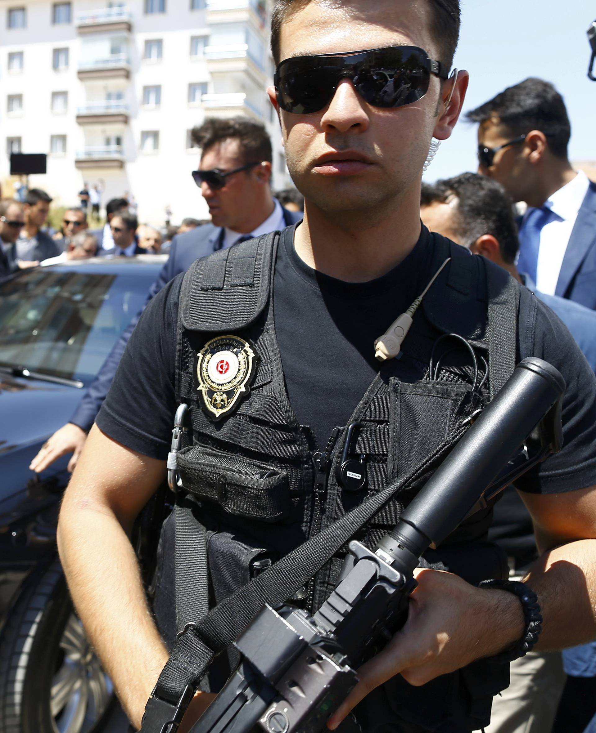 Security guard the car of Turkish PM Yildirim before a funeral service for a victim of the thwarted coup in Ankara