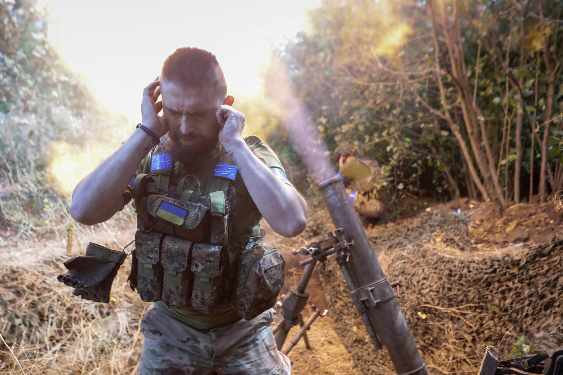 Ukrainian servicemen fires a 120-mm mortar towards Russian troops at a frontline near the town of Chasiv Yar