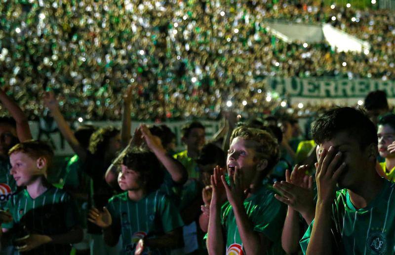 Youth players of Chapecoense soccer club pay tribute to Chapecoense's players at the Arena Conda stadium in Chapeco