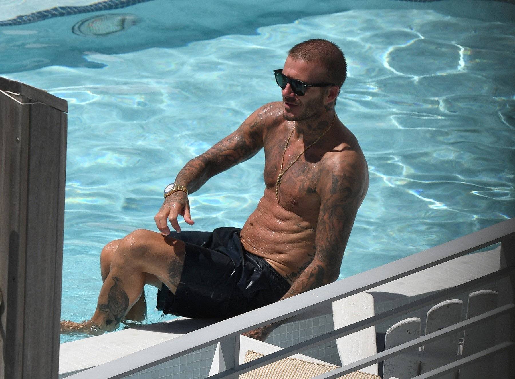 Shirtless David Beckham celebrates his new team, Inter Miami, as he has a few cocktails and takes a dip in the pool in Miami