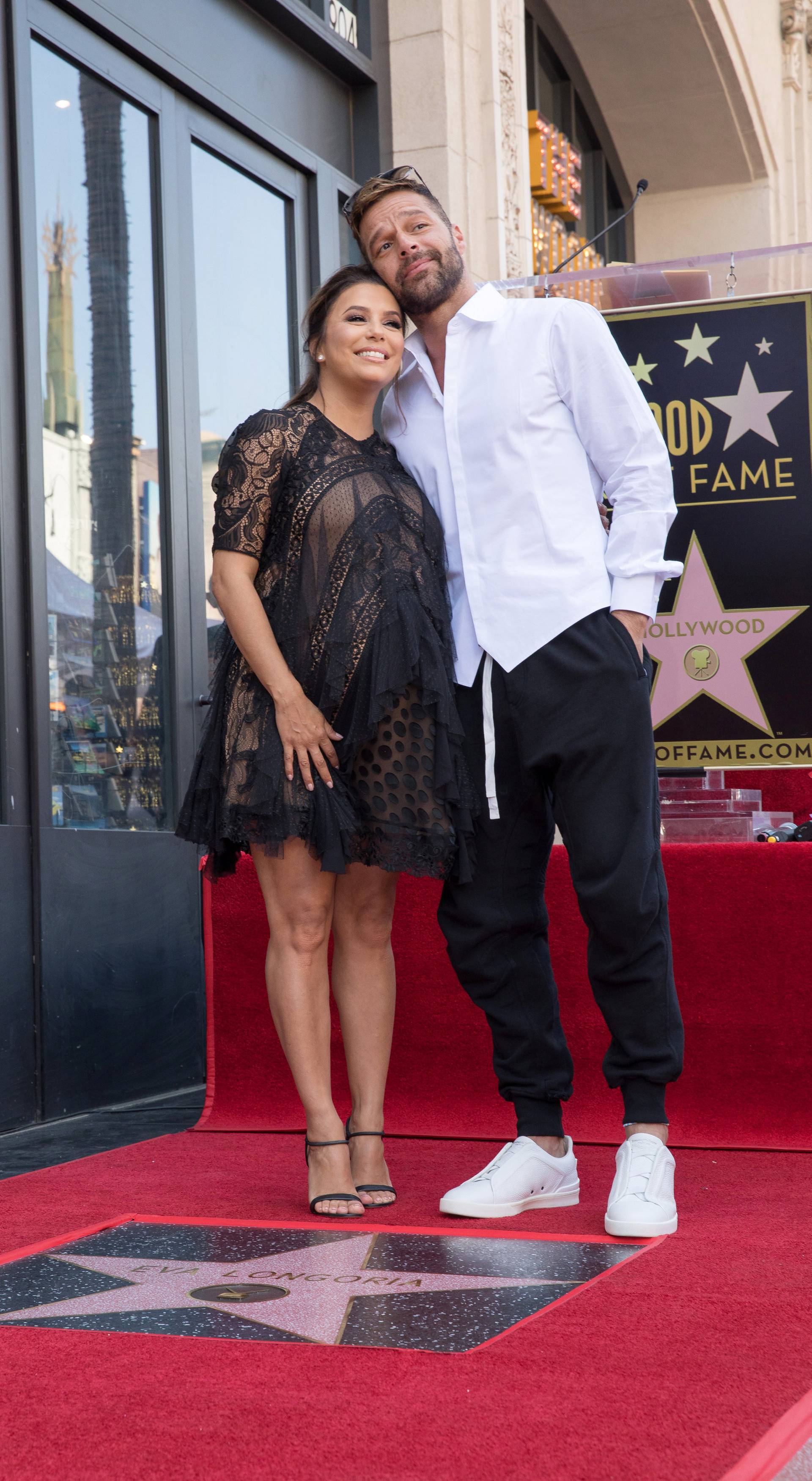 Eva Longoria and Ricky Martin pose on the Hollywood Walk of Fame in Los Angeles